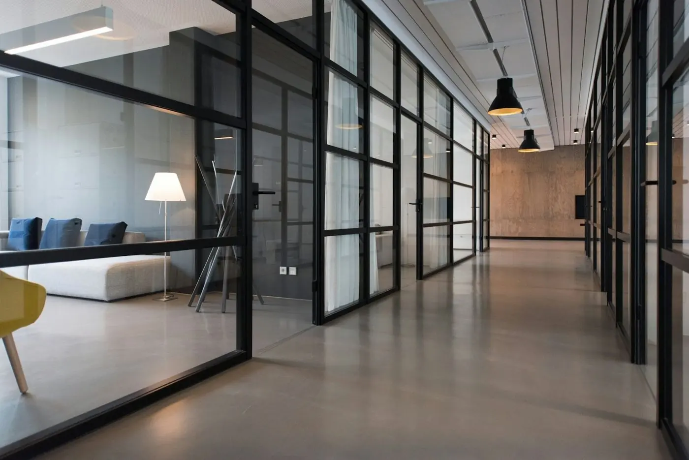 Glass-partitioned office corridor
